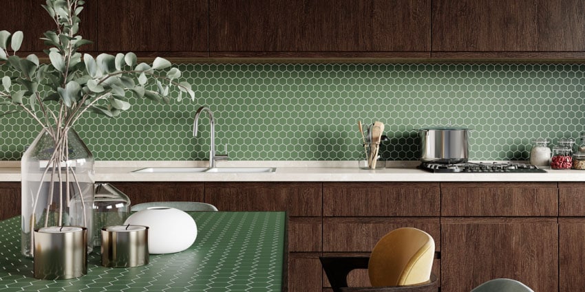 Kitchen with hexagon mosaic backsplash, countertop, wood cabinets, table, vase, and kitchenware