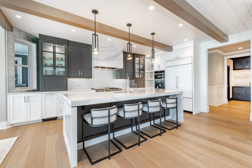 Grey cabinets, pine floors and white island