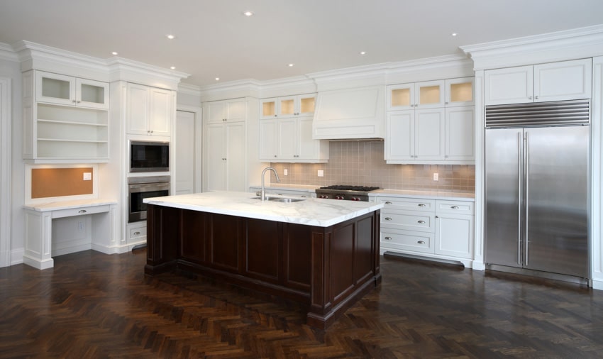 Kitchen with cabinets, lighting and wood island with white countertop