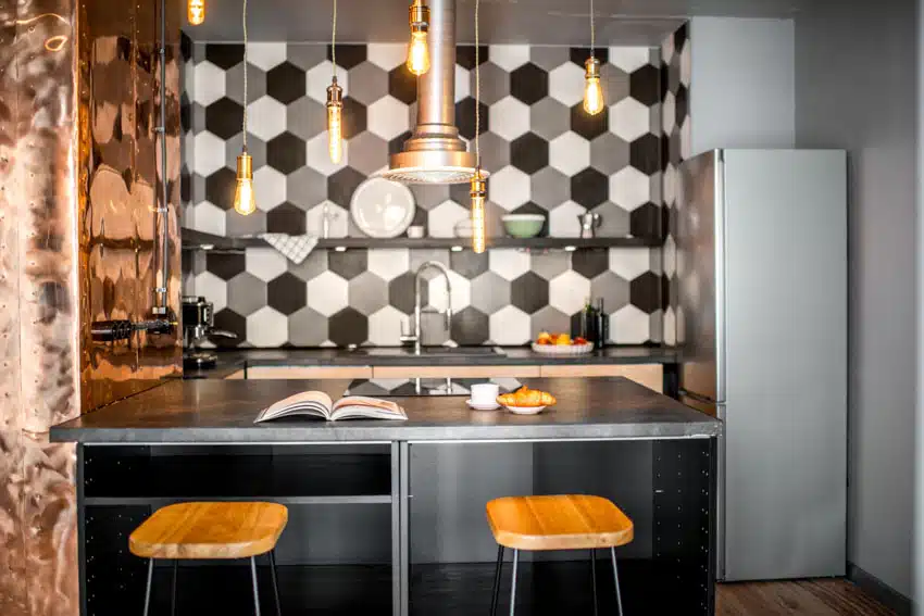 Kitchen with large hexagon tile backsplash, countertop, pendant lights, range hood, and stools