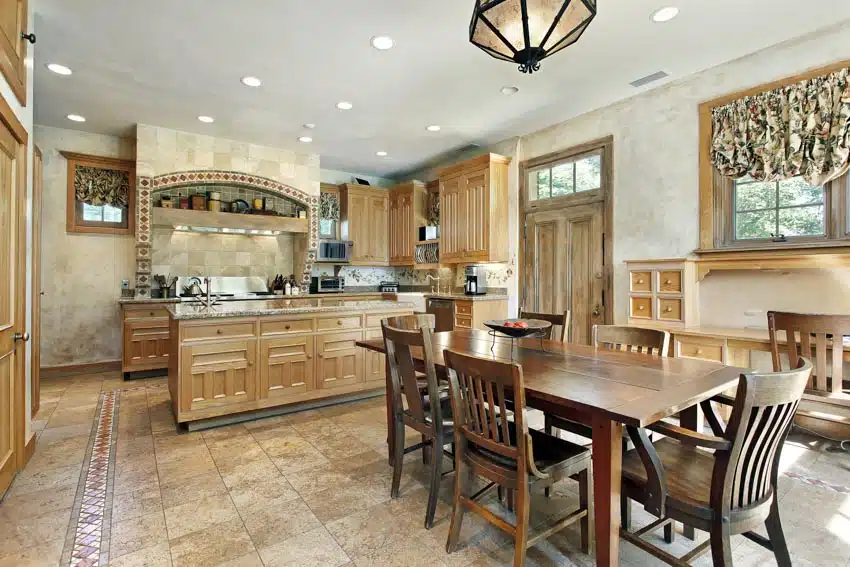 Kitchen with listello floor tile, table, chairs, island, range hood, ceilings, door, windows, and curtains