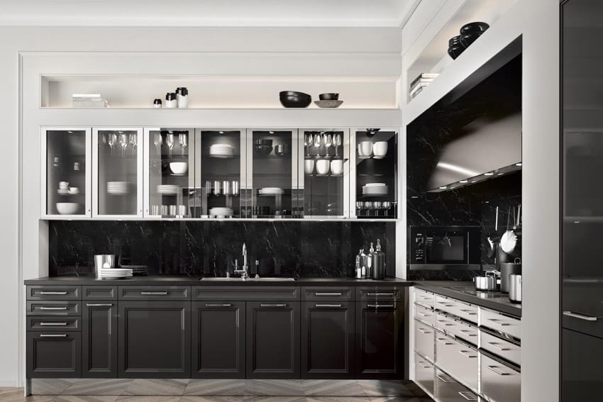 Kitchen with modern glass cabinets, backsplash, countertops, sink, faucet, and herringbone pattern floors
