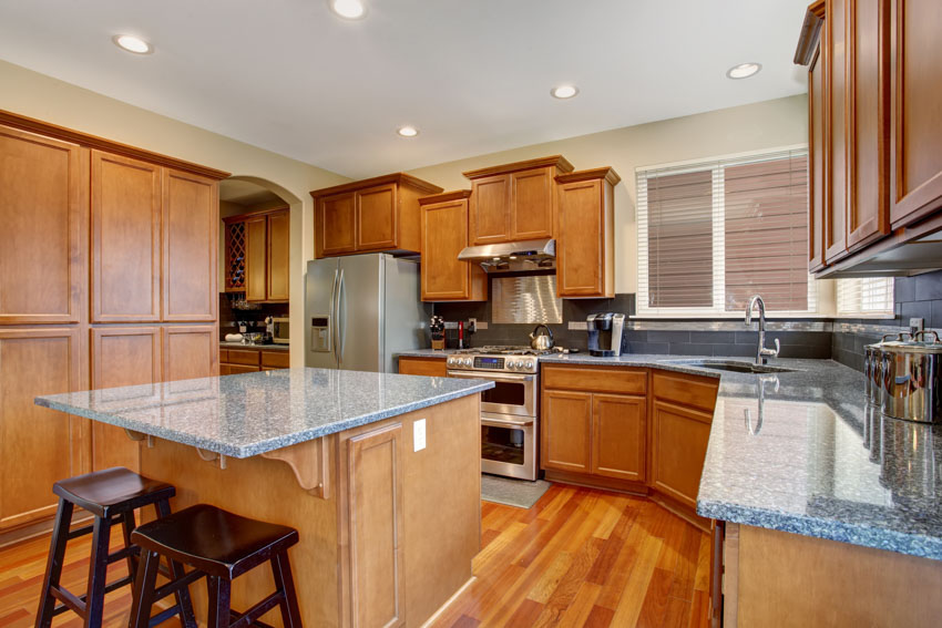 Kitchen with bar stools and granite countertop