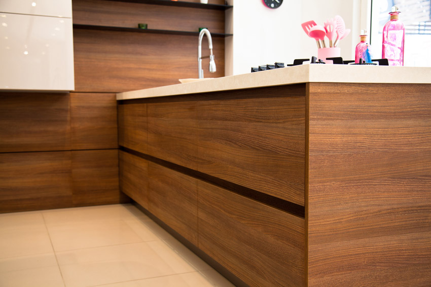 Kitchen with self sticking wood veneer cabinets, sink, and faucet