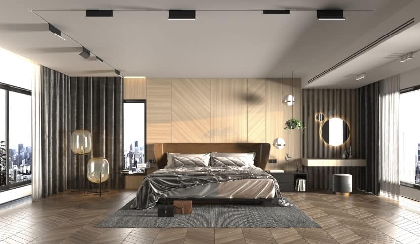 Large modern bedroom with stylish lighting fixtures and gray carpet on parquet floor