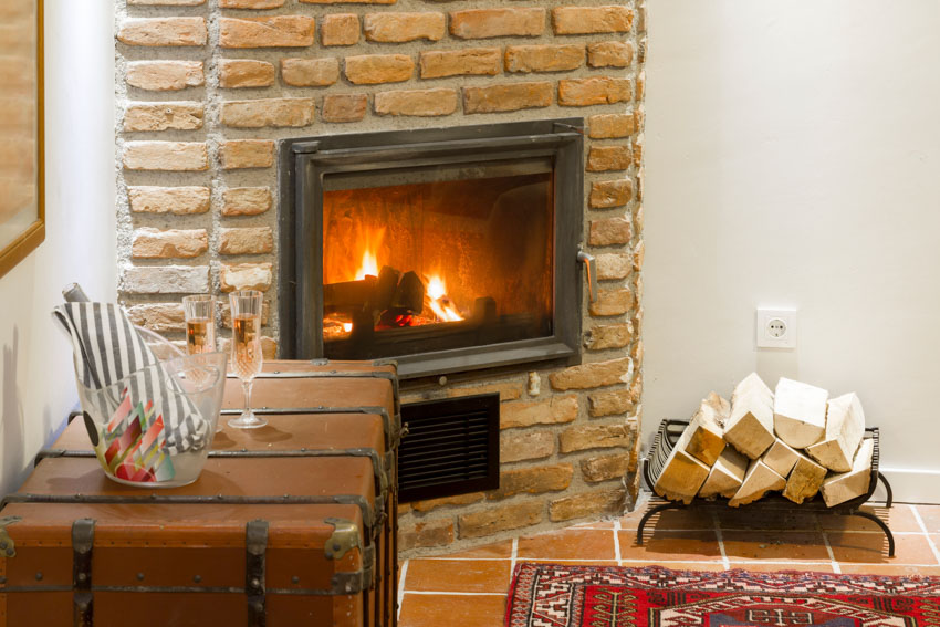 Living room with wood burning fireplace made of brick and chimney liner