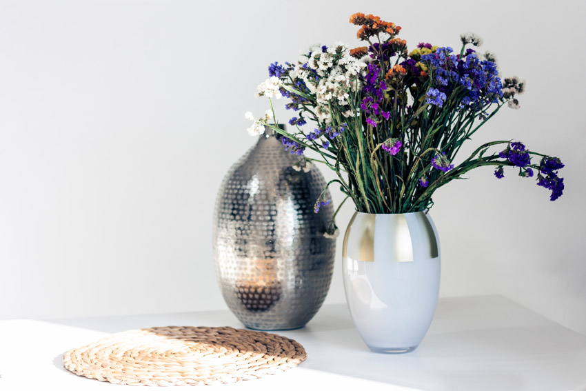 Metal vases with flowers for home interiors
