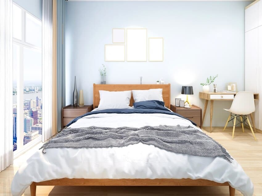 Bedroom with sea blue walls, wooden bed, and panoramic windows