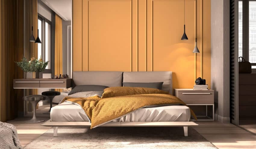 Orange brown toned bedroom with pendant lights and wooden floor