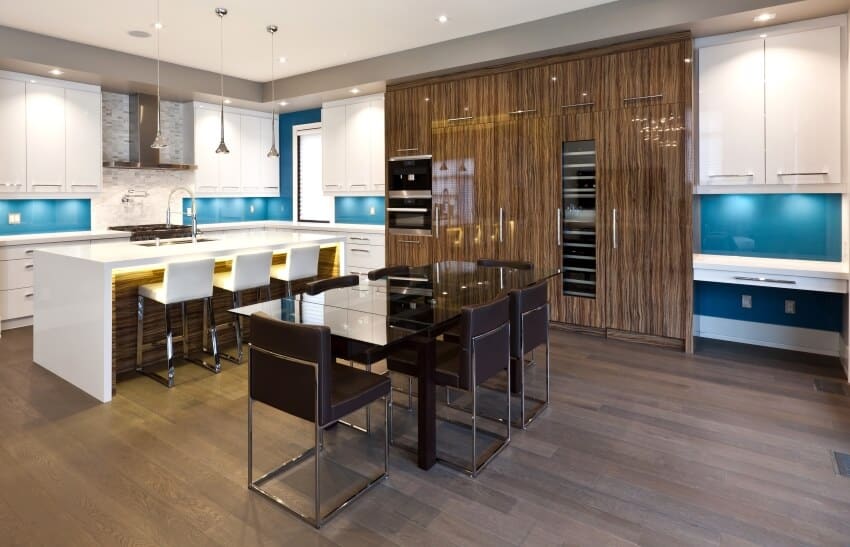 Modern kitchen and dining area with blue backsplash and glossy dark wood cabinets