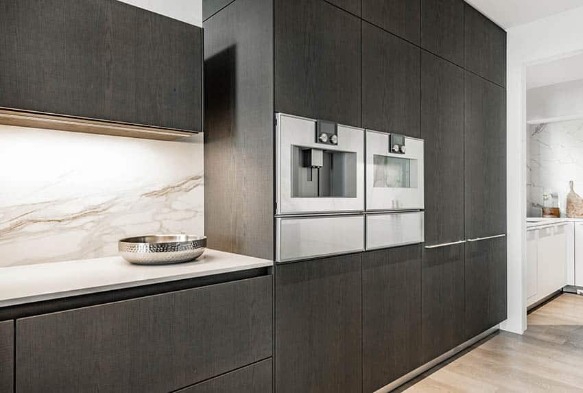 Modern kitchen with cream porcelain slab backsplash black veneer cabinets