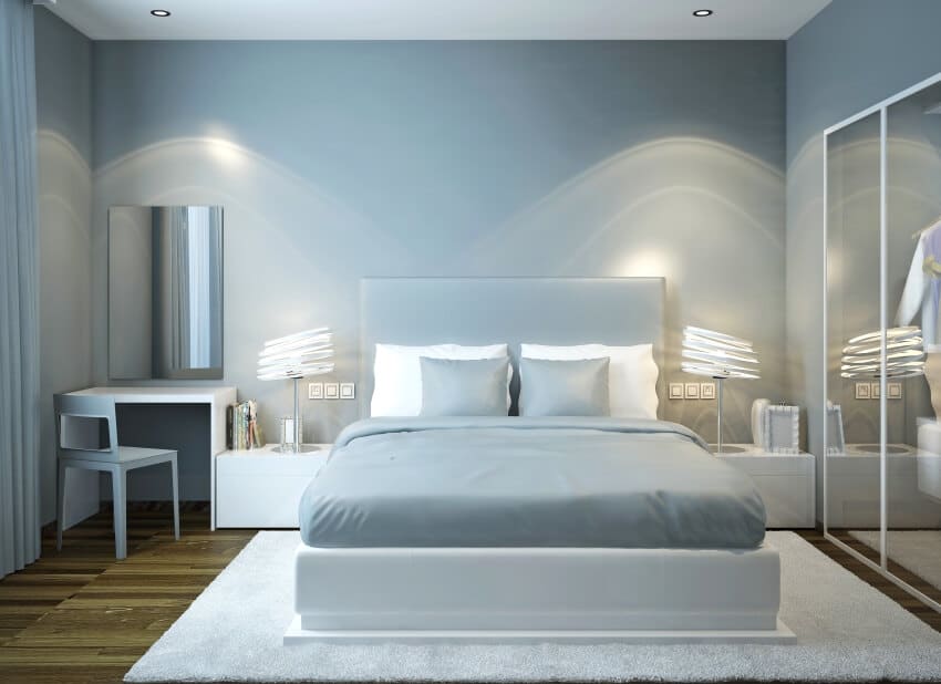 Light blue master bedroom with mirrors and stylish lampshades