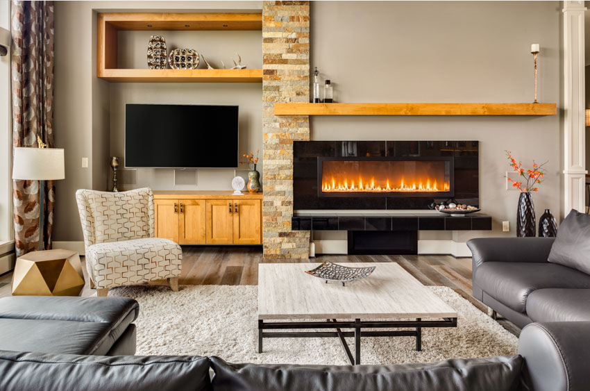 Room with accent chair, brown curtains, white center table, dark gray sectional and floor lamp