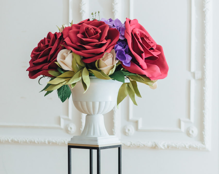 Pedestal vessel with red and purple flowers