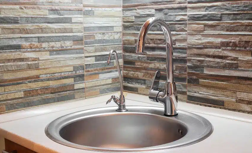 Slate backsplash, faucet and steel kitchen sink 
