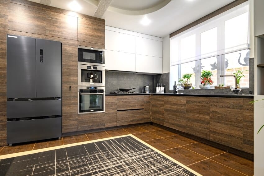 Kitchen with brown tile floors and modular cabinets
