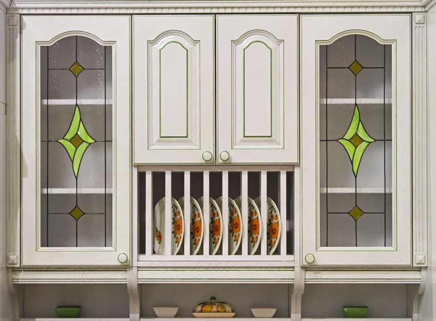 White cabinet with plates and decorative stained glass