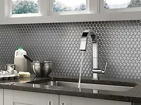 Stainless steel backsplash and chrome faucet with running water