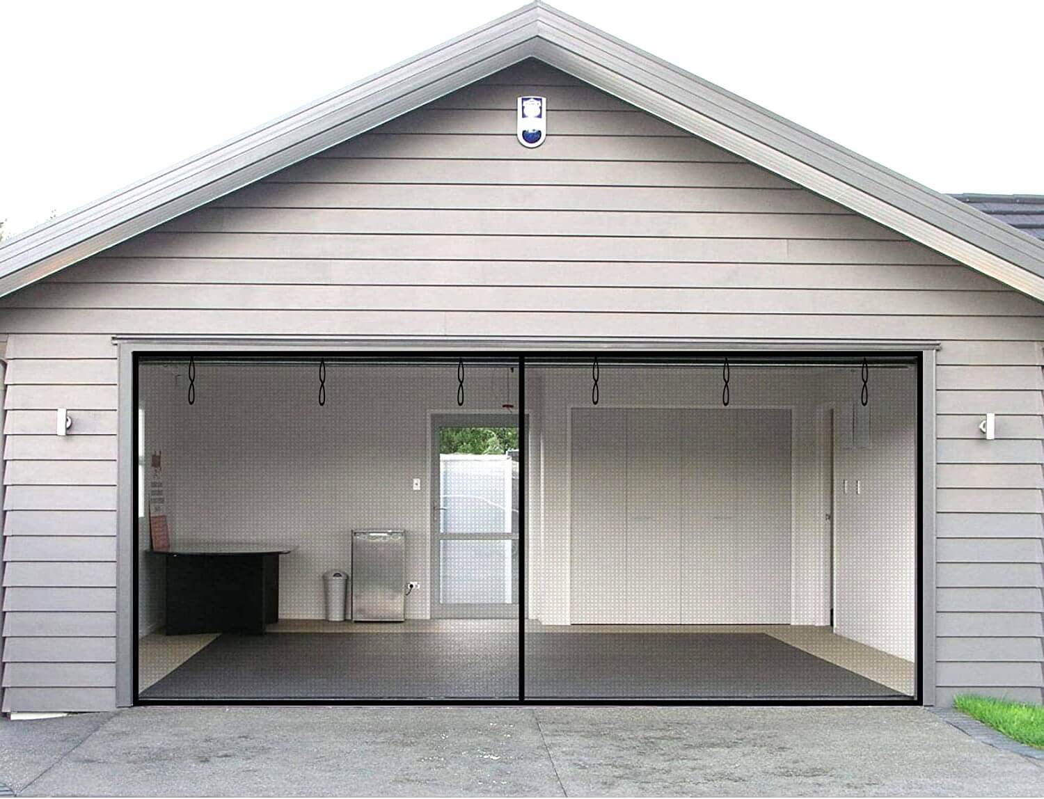 Two car garage with shiplap siding and garage door screen