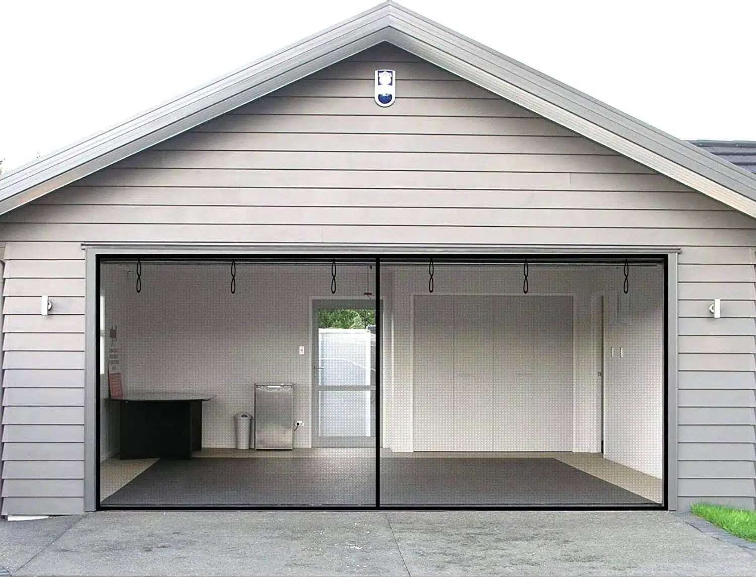 Two car garage with shiplap siding and door screen