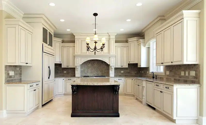 U shaped kitchen with antique white cabinets and clean slate backsplash