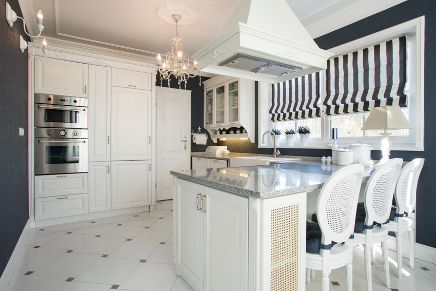 Kitchen with chandelier, diamond design flooring and breakfast bar with quartz counters 