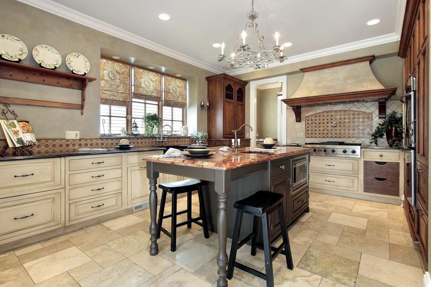 Kitchen with tile floors, island, stools, countertop, floating shelves, chandelier and backsplash