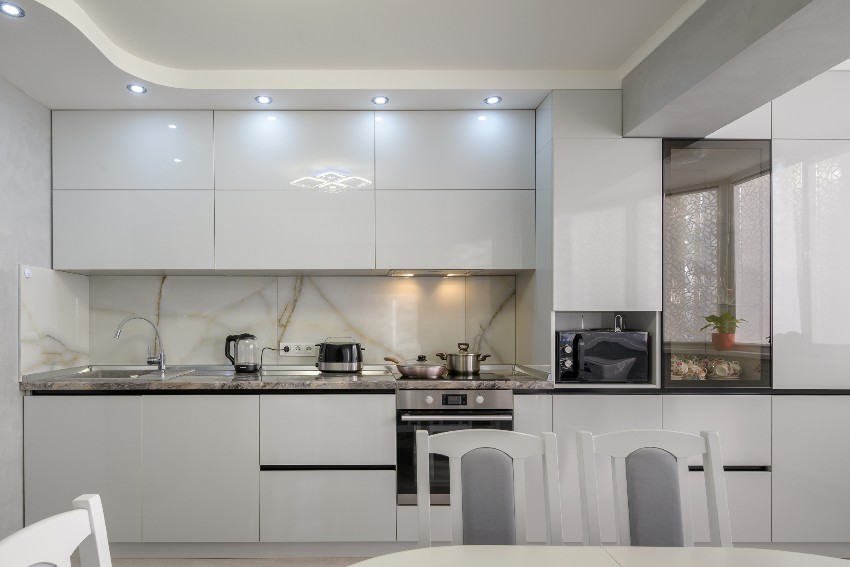 Well designed modern trendy white kitchen interior with pvc cabinets