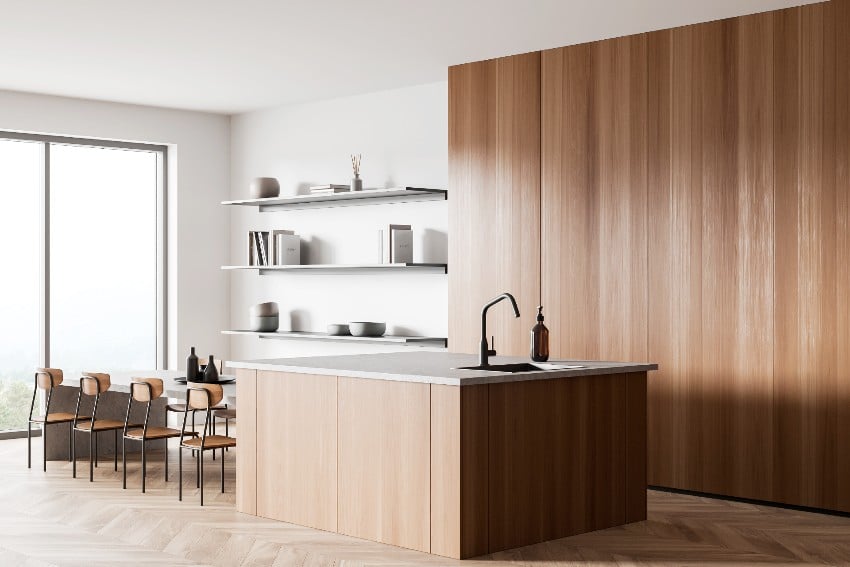 White and wood kitchen with dining table and chairs on hardwood floor, cooking area with sink and countertop