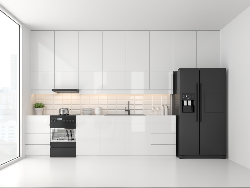 White kitchen with cabinets, black refrigerator, oven, and tile backsplash