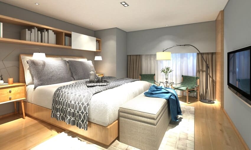 Wooden modern bedroom interior with gray walls and bed, floor lamp, and green armchairs