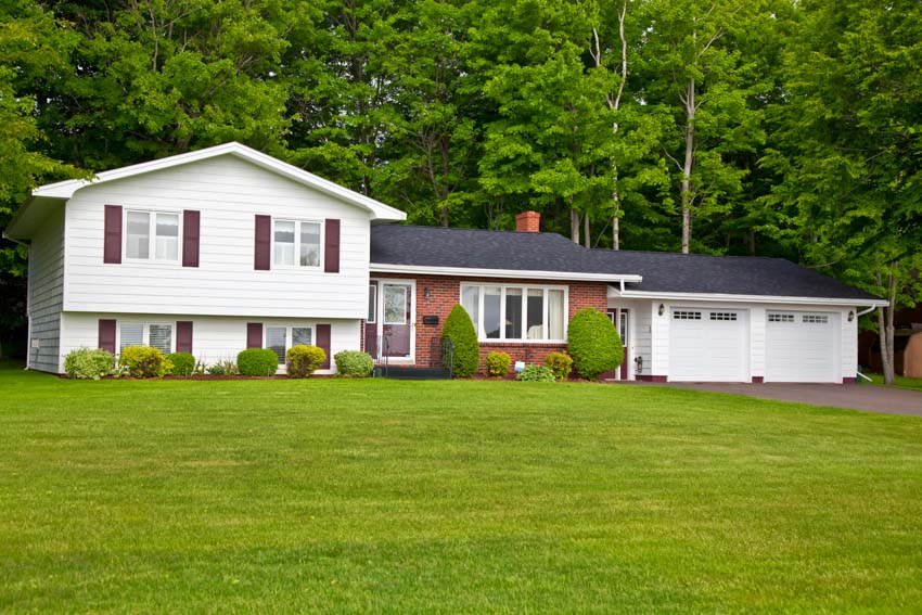 1970s house with white siding, windows and chimney