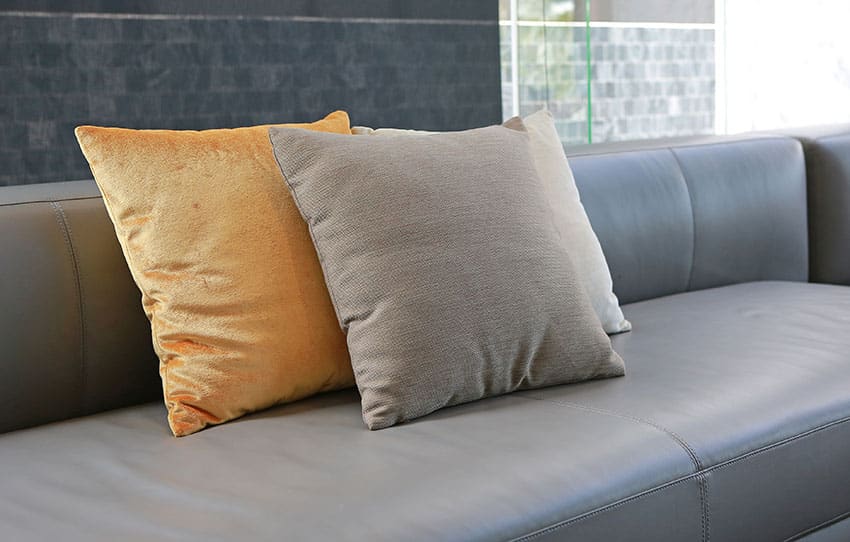 Black leather sofa with throw pillows