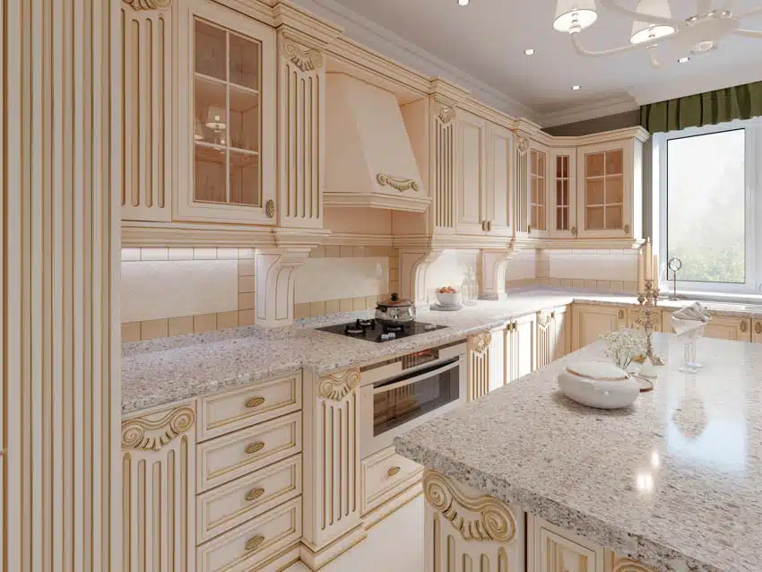 French country kitchen with white cabinets, tile backsplash, island, granite countertops, stove, range hood, and window
