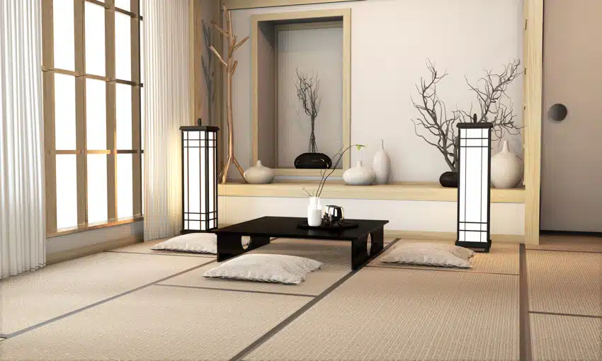 Japanese themed living room with tatami mats, small table, vases, and floor pillows