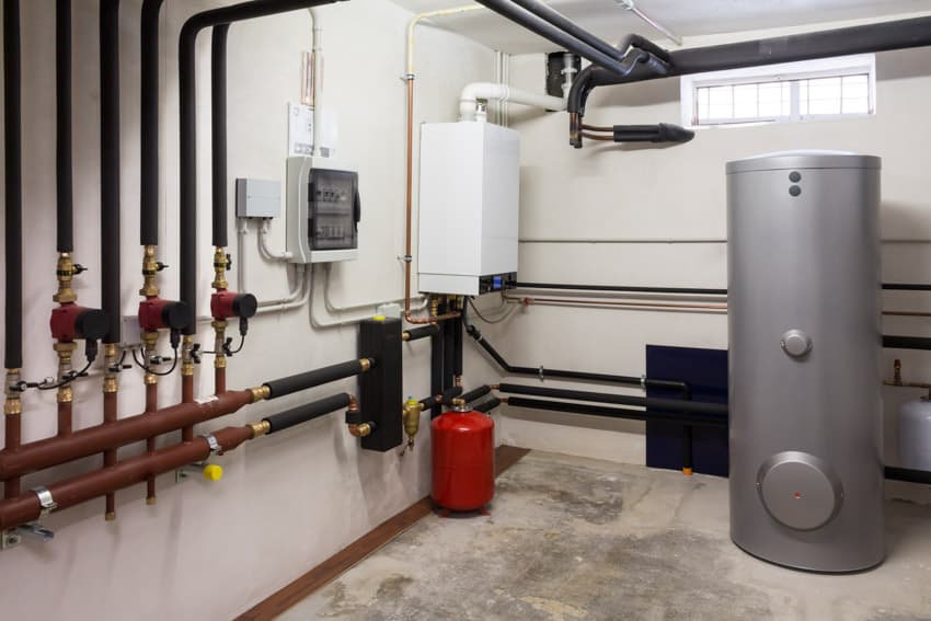 Basement interior with a small window and hybrid water heater