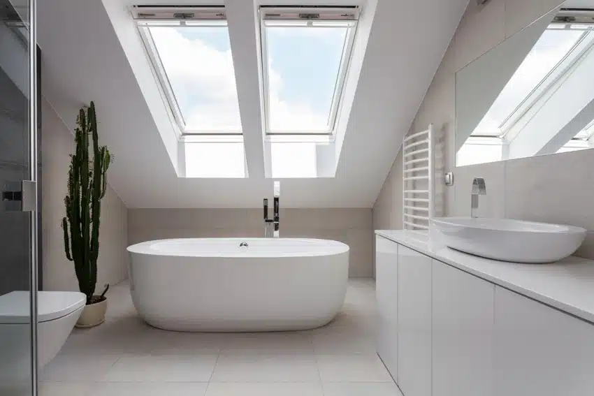 Bathroom with tub, sink, cabinets, matte porcelain tile floor, and skylight window