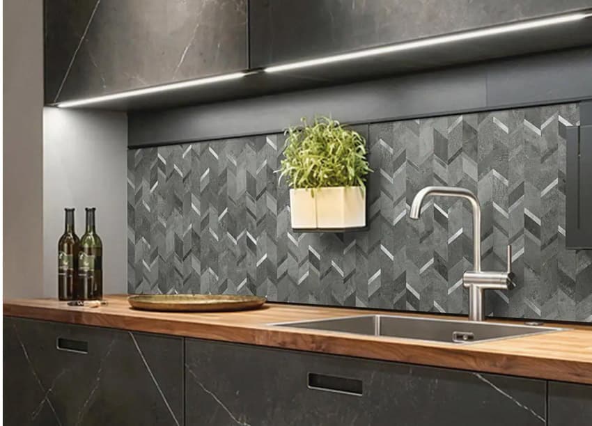 Black kitchen with modern chevron tile backsplash, wood countertop, cabinets, sink, and faucet