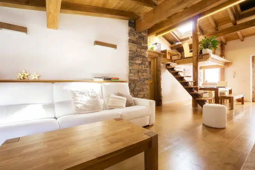 Chalet style flat interior with white walls, floating shelves and furniture