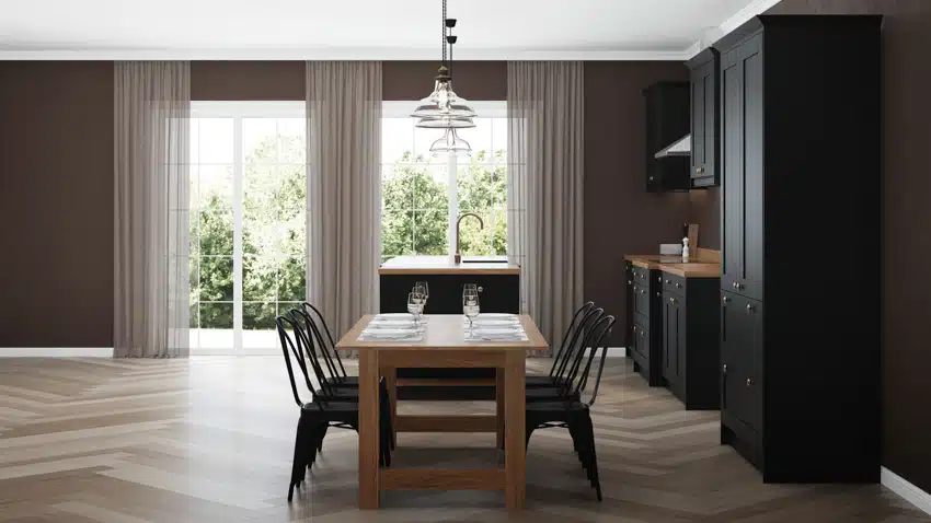 Kitchen with black cabinet, table, chairs, countertop and curtains