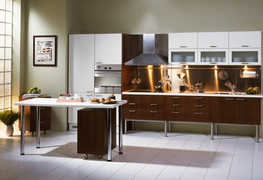 Kitchen with glass cabinets, table, copper backsplash, range hood, stove, and window