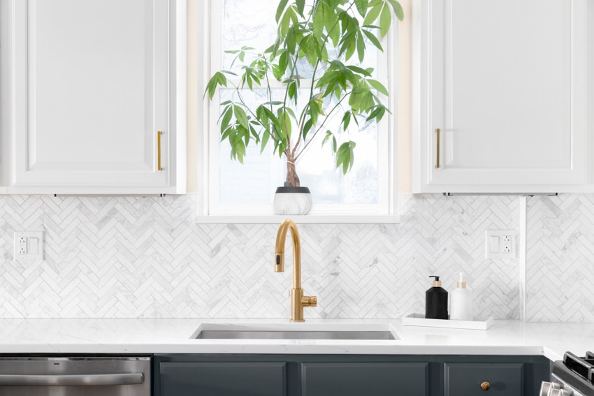 Contemporary kitchen with herringbone backsplash, countertop, sink, and faucet