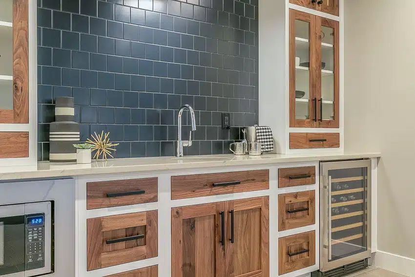 Contemporary kitchen with square subway tile backsplash, countertop, faucet, cabinets, and wine cooler