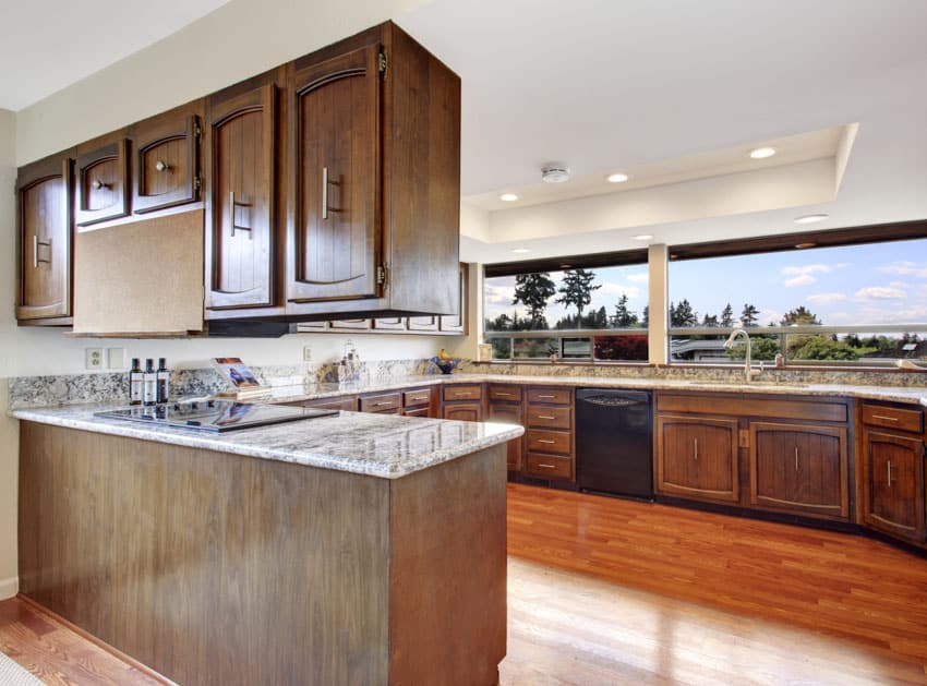 Kitchen with wood flooring, wraparound windows and breakfast counter