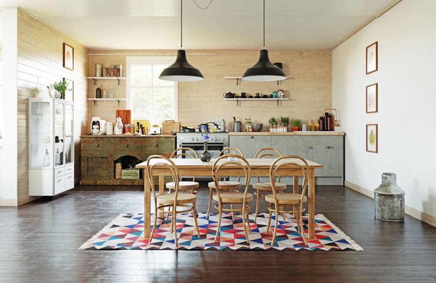 Kitchen with wood dining set, geometric carpet and accent wall