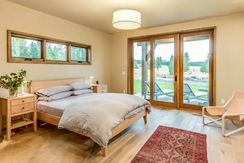 Room with beige walls, carpet, sliding door and drum ceiling lights