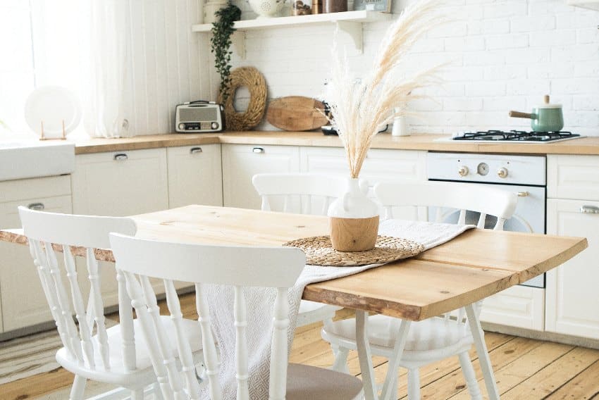 Danish style kitchen with wood accents and white dining chairs