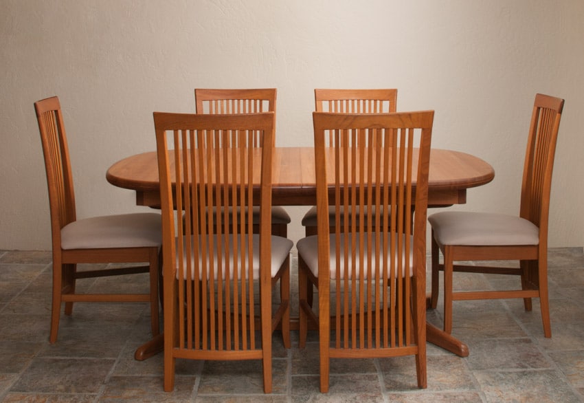 Frank Lloyd Wright style chairs, dining table, stone tile flooring, and pendant light