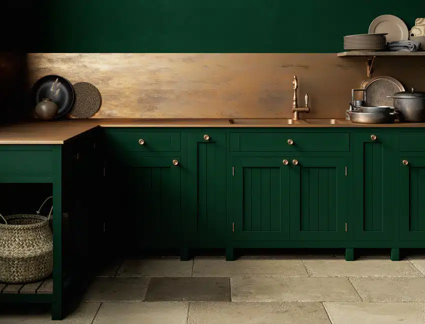 Kitchen with green cabinets, wood countertop. wicker basket and stacked plates