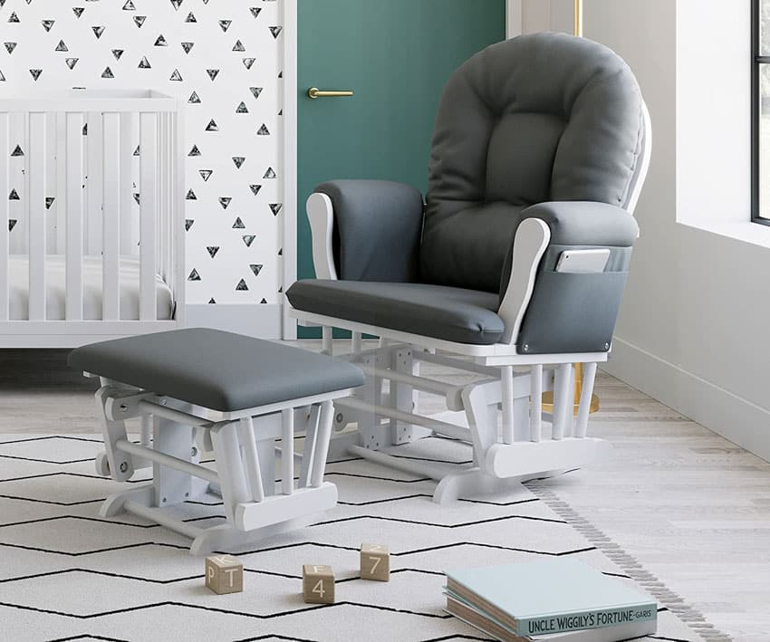 Glider chair in nursery with crib, ottoman, and green door